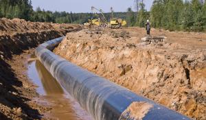 workers construct gas pipeline over groundwater