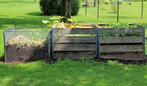 Image: three compost bins in a yard. Topic: 6 Popular Composting Options