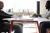 two men sitting at their desk