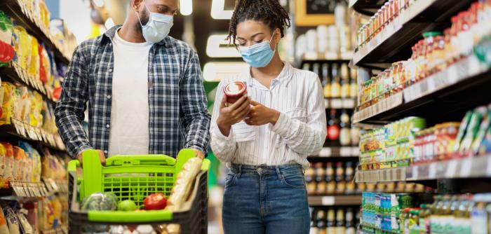 Image: couple in a supermarket. Topic: Don't Discount Our Future, Trader Joe's