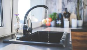 Image: running kitchen faucet. Topic: The Facts About Water Filters
