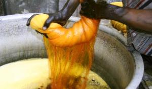 Image: person wringing out dyed fabric. Topic: Toxic Textiles Report