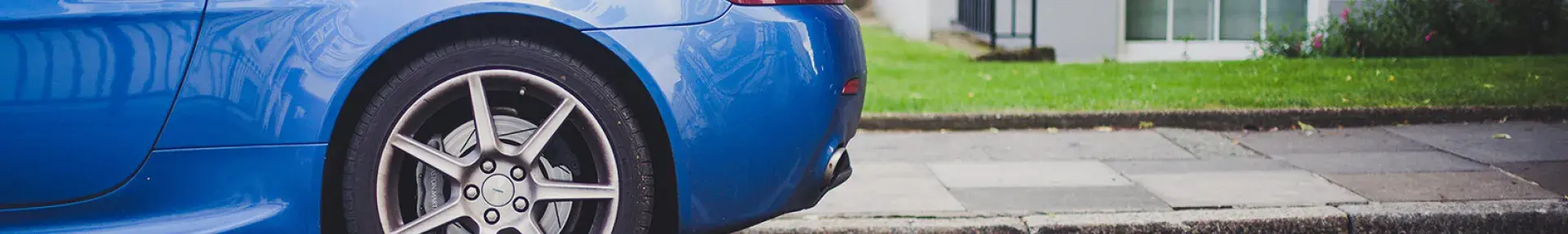 Image: blue car in parking spot. Topic: Reduce Your Carbon Footprint