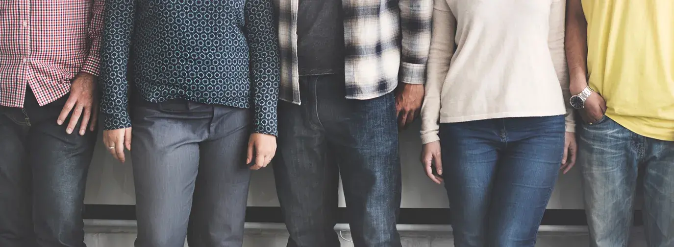 Image: people lined up in different outfits. Topic: 7 Tips for Less Toxic Clothing