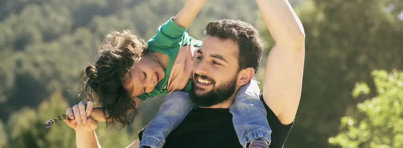father lifting his daughter playfully