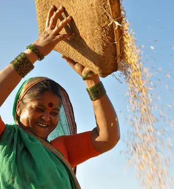 Image: woman pouring out a basket of grain. Topic: Green America®澳洲体彩幸运5官方网站's Work on Labor Rights