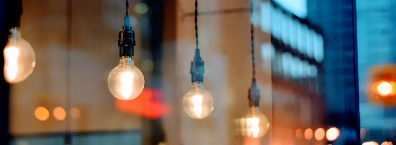 Image: light bulbs in a cafe. Topic: CFLs vs. LEDs: The Better Light Bulbs