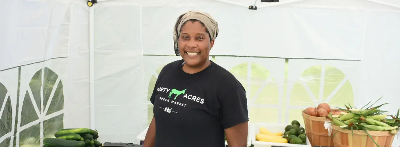 Liz Abunaw poses in her market in a tent