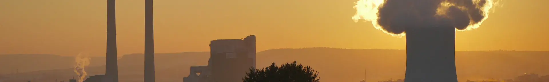 Image: factory smokestacks and smog. Topic: Dirty energy.