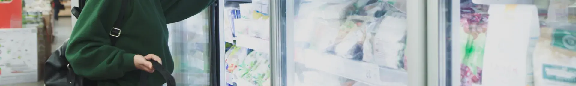 Image: shopper standing in front of supermarket coolers. Topic: Cool It for Climate