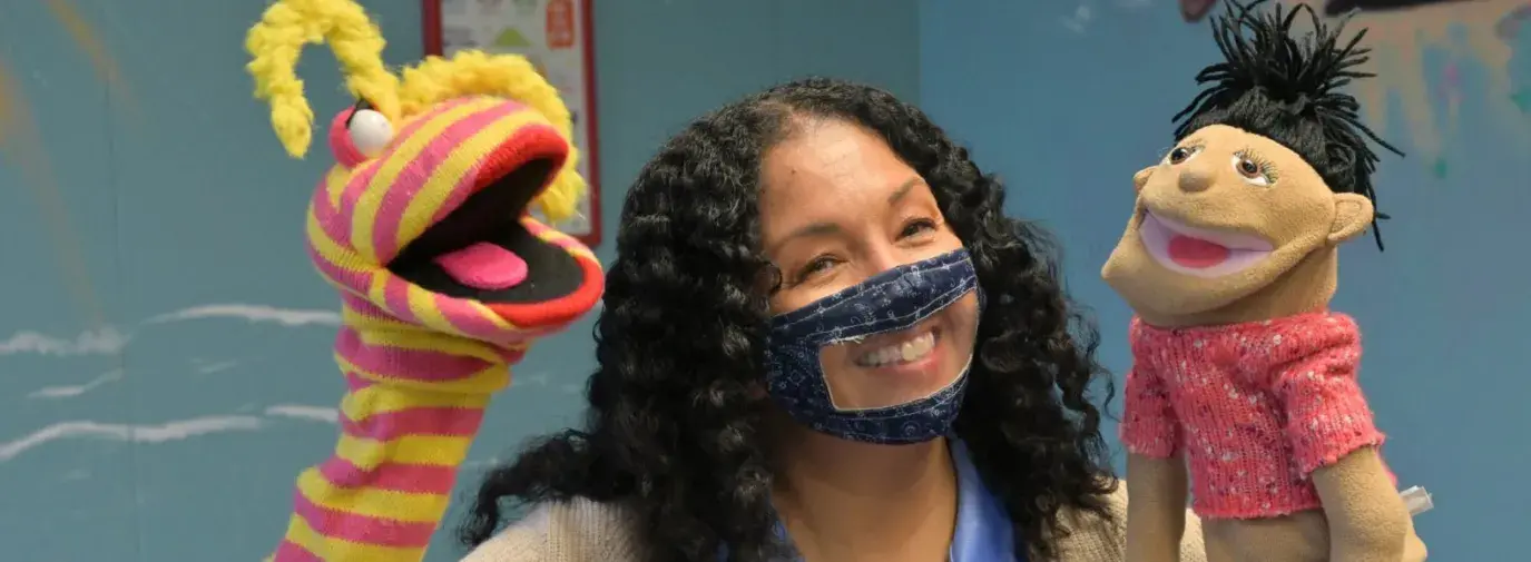 woman holding puppets