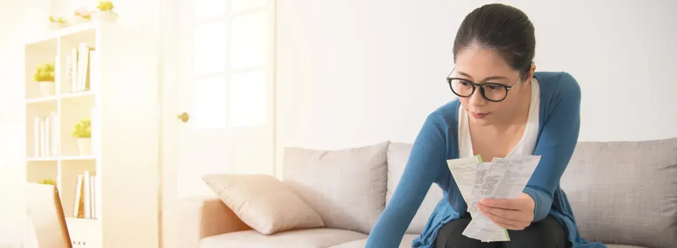 woman accounting and holding paper receipts